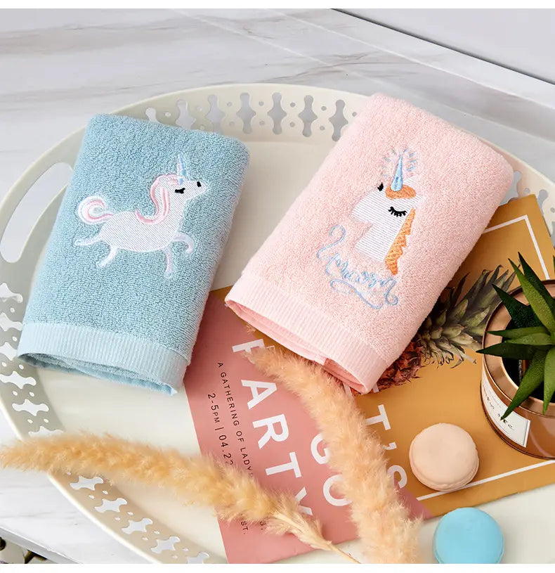 Plush pure cotton bath towels in pink and blue with embroidered unicorn motif