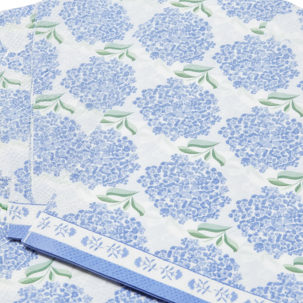 Close-up of blue hydrangea floral pattern on matte paper napkins