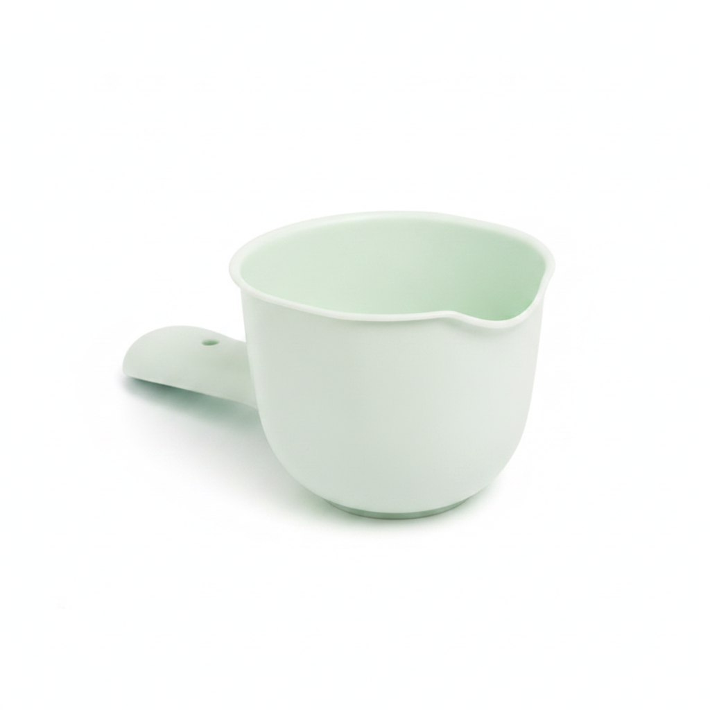 Mint green plastic kids bath shampoo rinse cup and scooper on white background