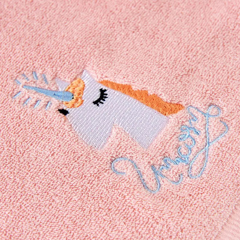Close-up of embroidered unicorn design on plush cotton towel