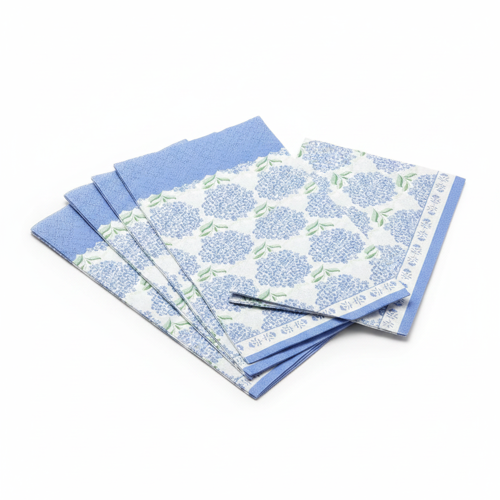 Fanned stack of blue hydrangea floral 3-ply paper guest napkins on white