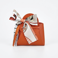 Orange PU leather handbag-shaped favor pouch with silk ribbon bow