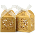 Gold laser-cut filigree favor boxes with cream ribbons