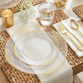 Clear gold filigree place setting with gold cutlery, tumbler and baby's breath