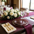 Burgundy gold-rim hammered plastic plates elegant wedding table setting with crystal glassware and white roses