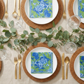 Green and blue artistic cocktail napkins styled garden party tablescape with gold cutlery and eucalyptus