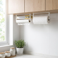 Compact wall-mount kitchen organizer holding paper towels under cabinet in a bright modern kitchen