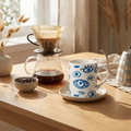 Artistic Eye Ceramic mug with bold eye motif on a wooden tray with morning coffee setup
